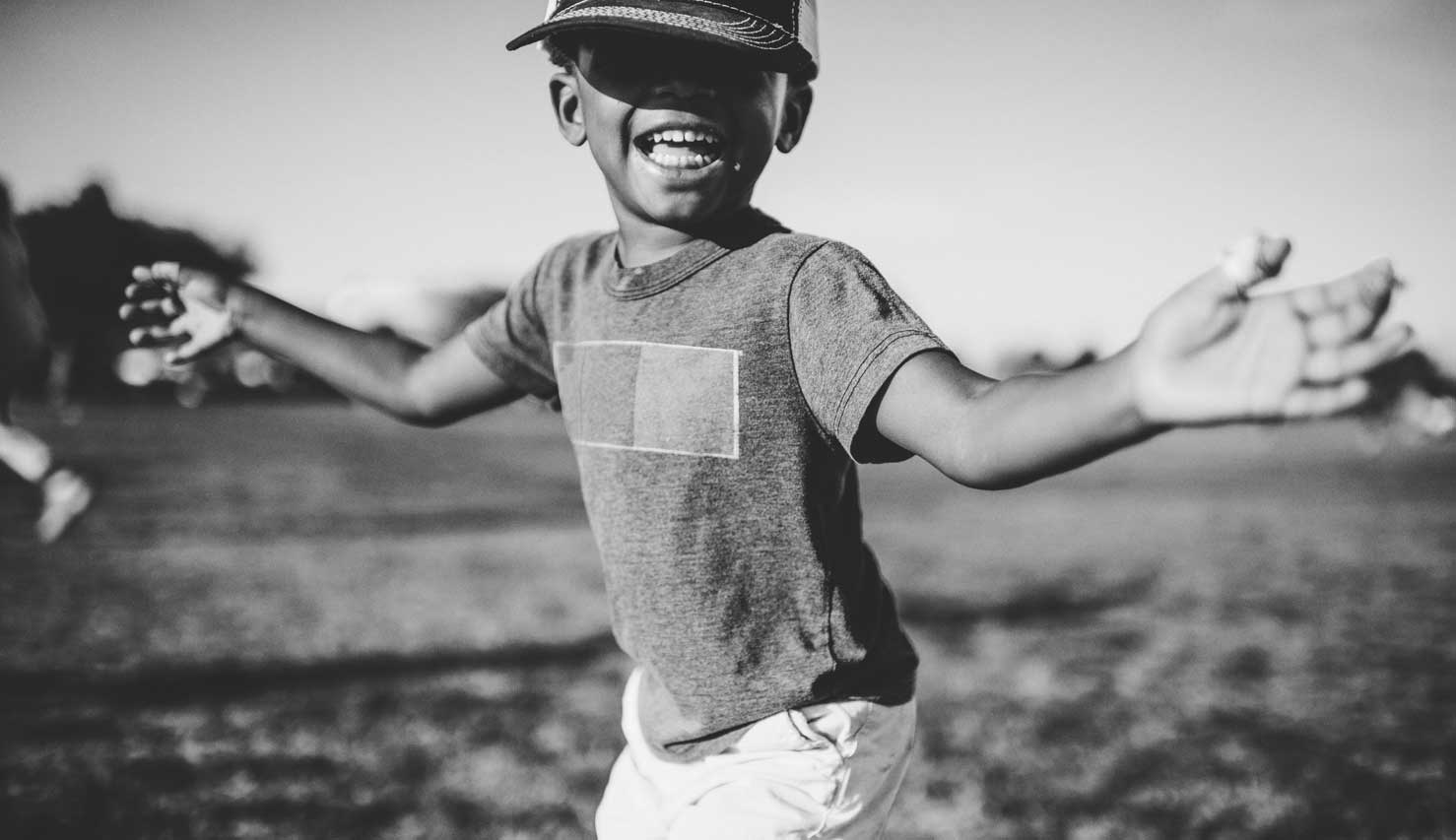 young boy smiling and playing